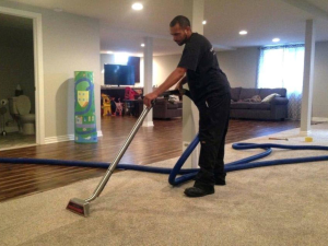 man performing water damage restoration on carpet